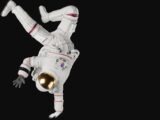 a person in a white space suit doing a handstand
