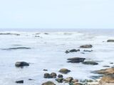 Peaceful view of rocks and waves at Mar del Plata beach, capturing the serene seascape.