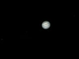 Jupiter and its four galilean moons in space