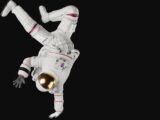 a person in a white space suit doing a handstand