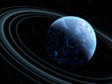 Blue planet with rings in outer space