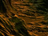 Textured rocky surface with orange and green hues