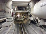 the inside of a large airplane with stairs leading up to it