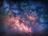 Colorful depiction of the Milky Way galaxy with vivid stars and nebulae visible from Earth.