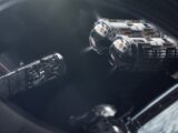 Two spacecraft approach a space station in orbit.
