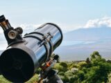 black and silver telescope on green grass field during daytime