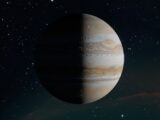 Stunning view of planet Jupiter with visible cloud bands and darkened hemisphere against a starry sky.