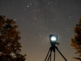 black camera with tripod during night time