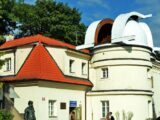 An observatory sits under a bright sky.