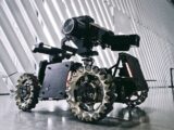 A black and white photo of a camera on wheels