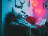 man in black helmet sitting on couch