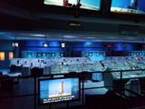 a room with many screens and monitors