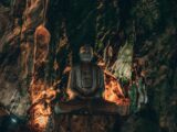 a statue of a buddha in a cave