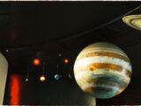 A model of the solar system with planets is on display at a science museum.