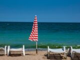 white wooden armchair on beach shore during daytime