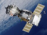 Close-up of Soyuz spacecraft orbiting Earth with solar panels extended, showcasing space exploration technology.